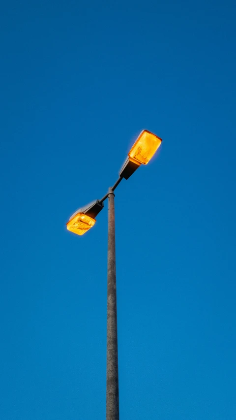 the side of a lamppost against a blue sky