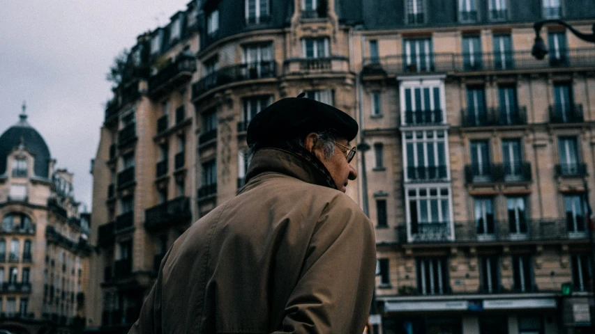 a man looking up in front of a very tall building