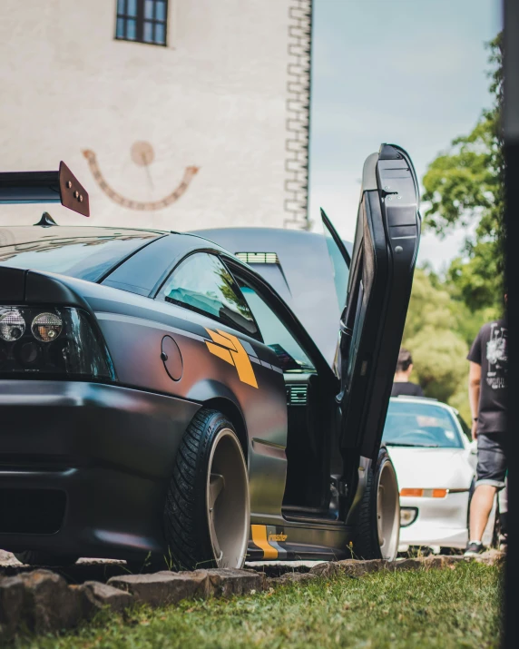 an car has its door open on a city street