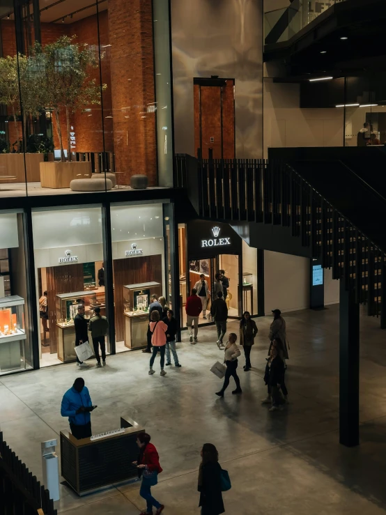 people walking around inside a store at night