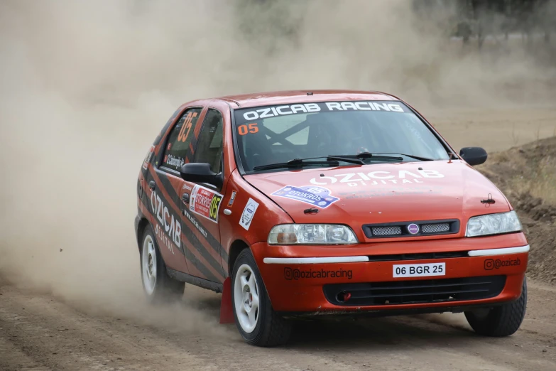 a red racing car coming around a corner