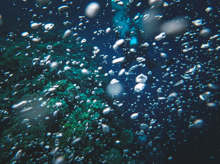 a rain - droplet on the windshield outside of a bus