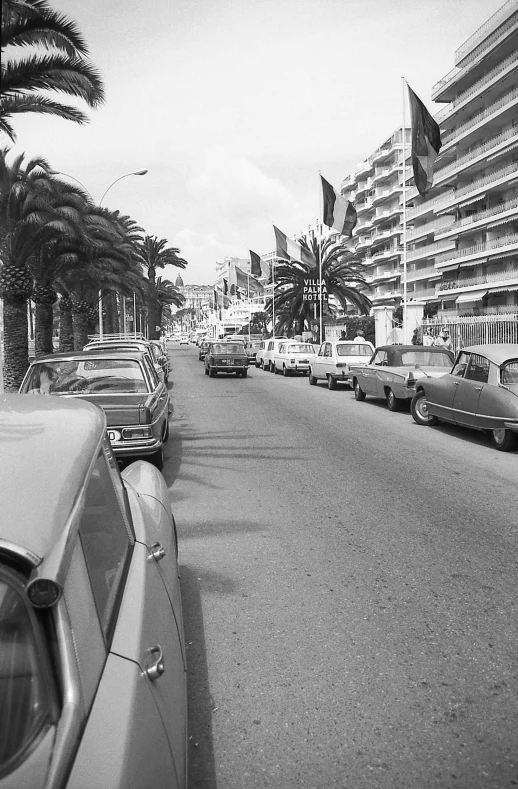 an old fashion po of cars parked on the side of a road