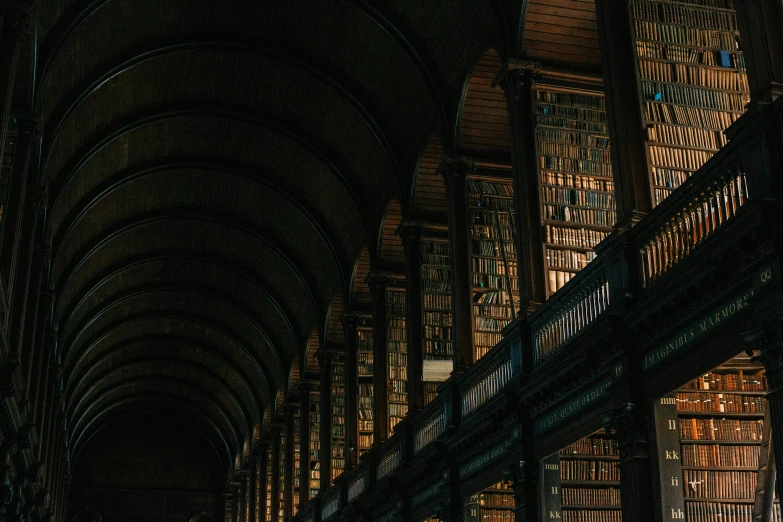 a large liry with bookshelves and columns with lights on