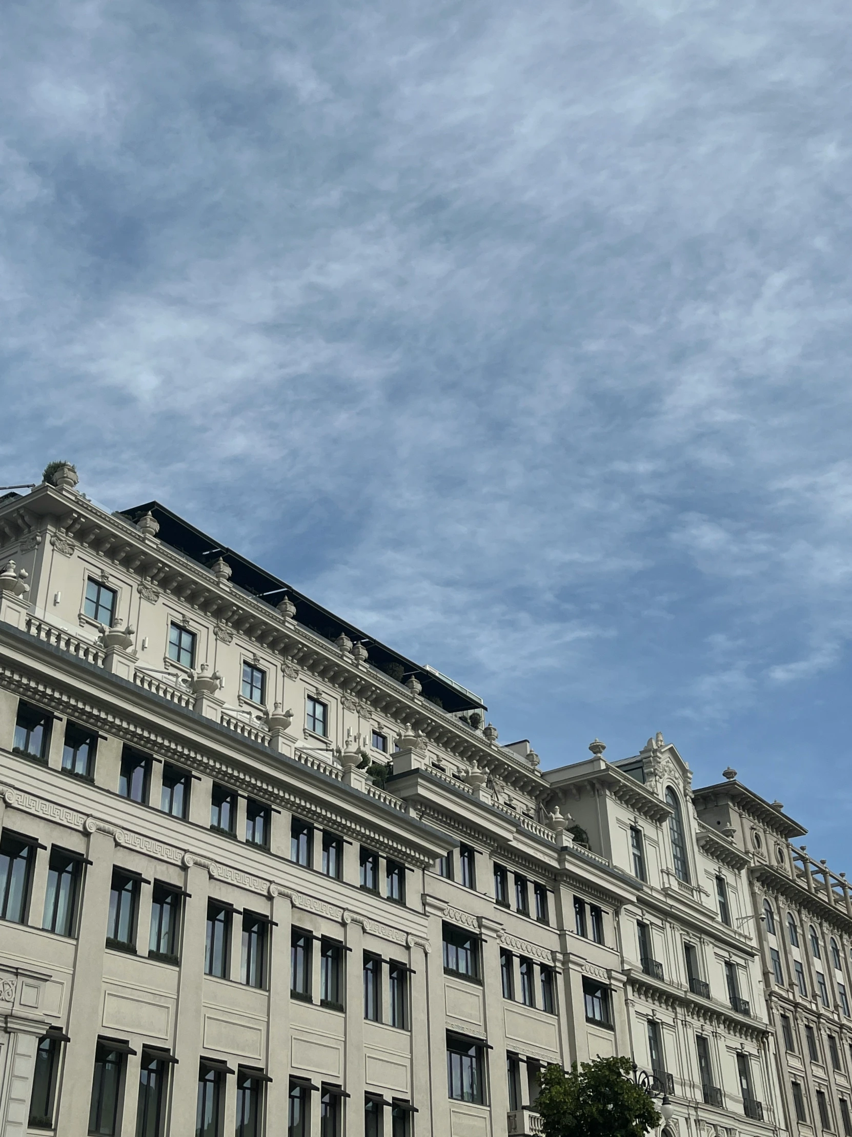 an airplane is flying in front of several buildings