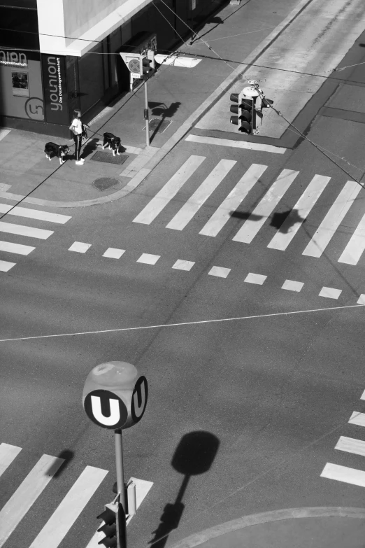 black and white po of an intersection with some signs and buildings