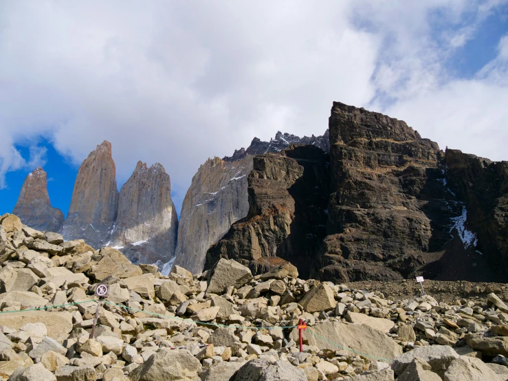 two men hiking up the rocky mountain, climbing to the top