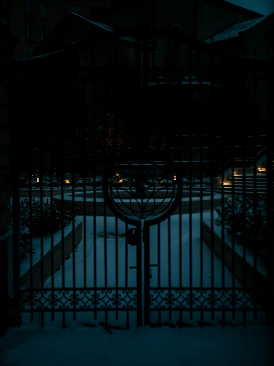 a dark street with some houses in the background