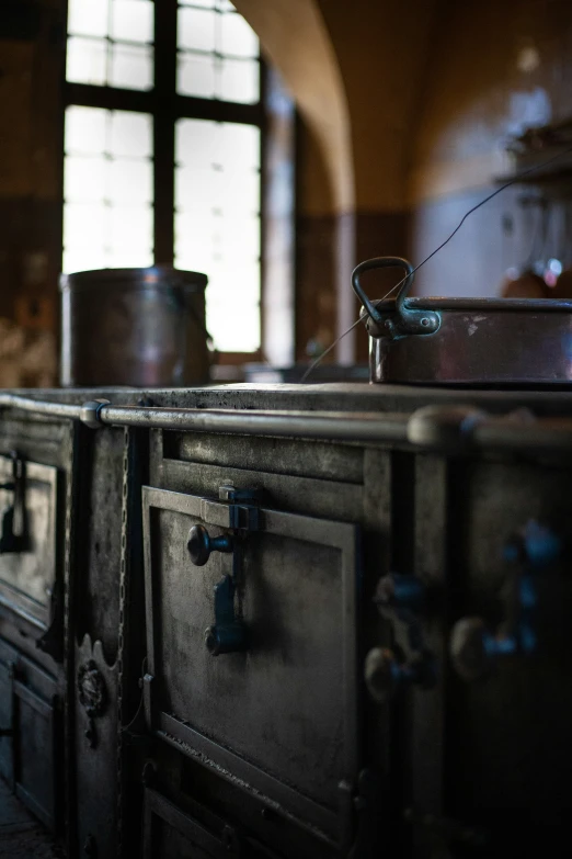an old fashioned kitchen stove top with pots on top of it