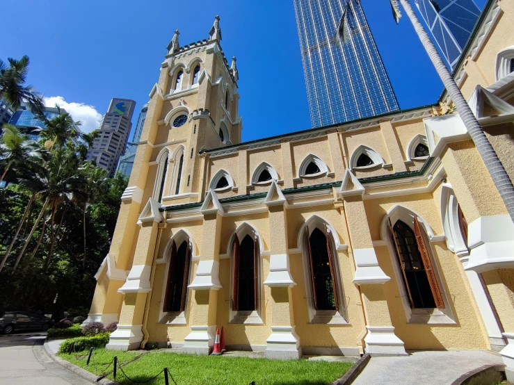 an ornate church with a green lawn near it