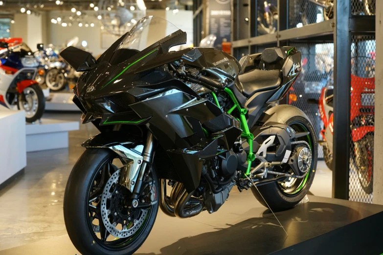 a futuristic motorcycle parked in a showroom with many bikes