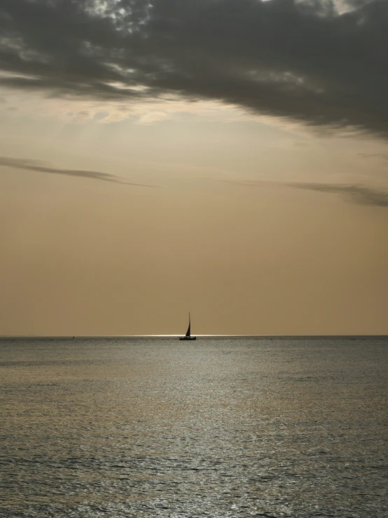 an ocean filled with a boat in the middle of the day