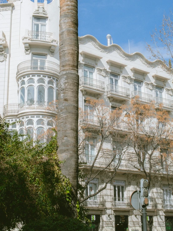 the side of a building has some large windows and balconyes