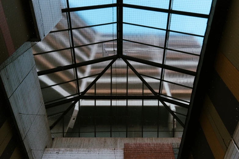 a hallway with glass doors and a train at the top