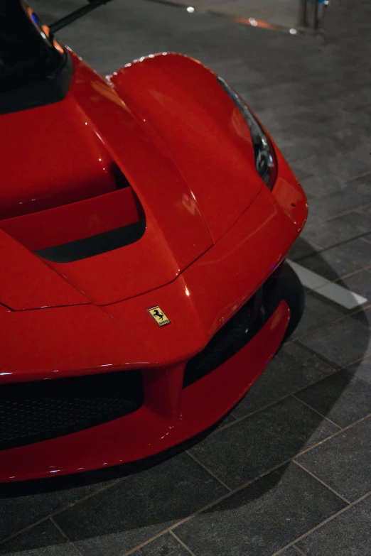 a close up of the front of a red sports car