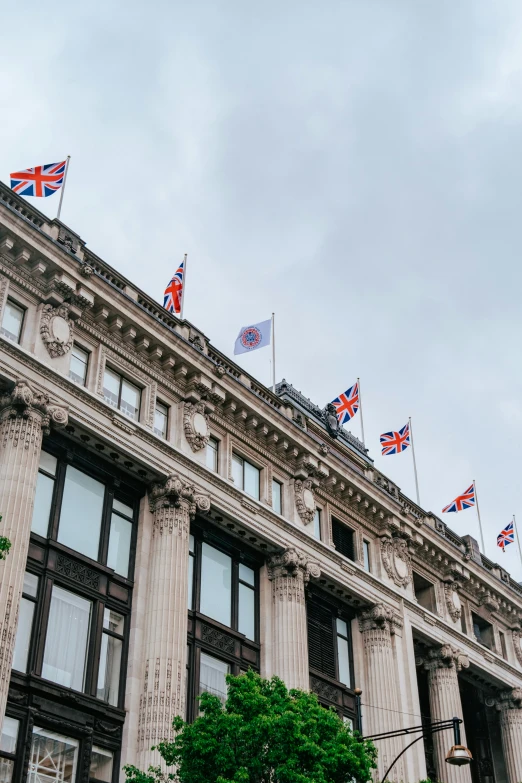 several flags on the side of a building