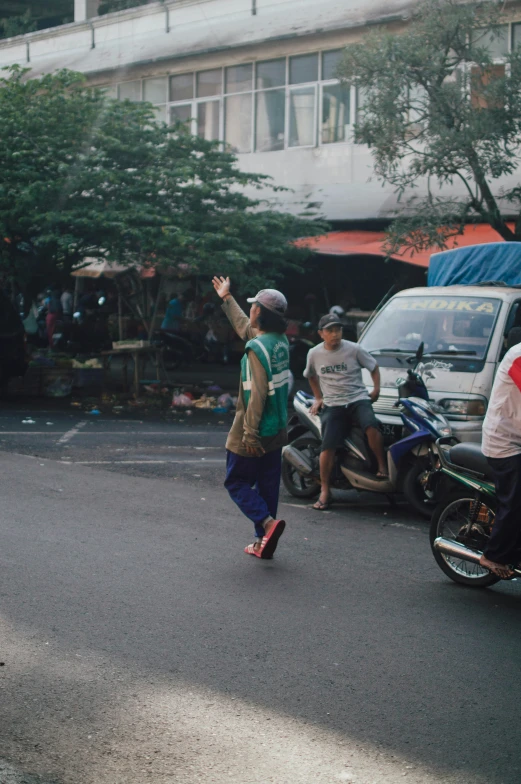 people standing around in the street looking at soing