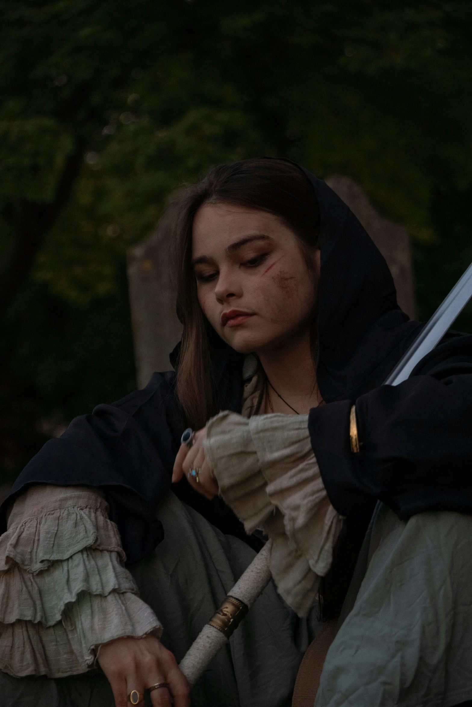 a woman with an umbrella and other accessories in the dark