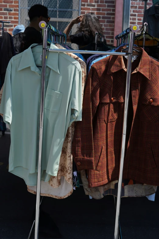 some long - sleeved shirts hanging on clothes line outside