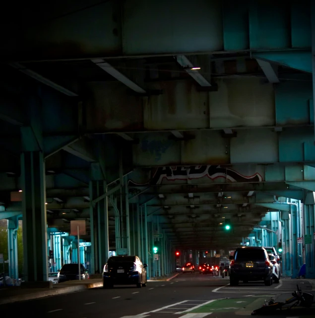 a very dark and overpassed building with cars and street lights