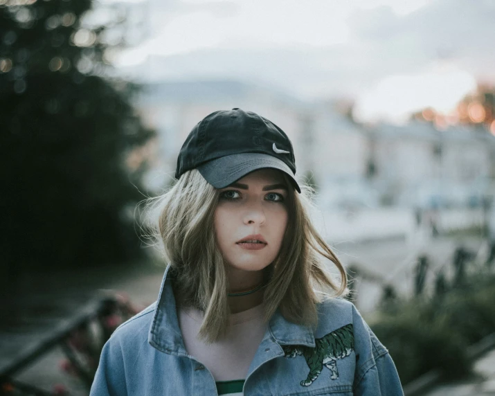 a young woman is standing in the background and a blurry cityscape can be seen