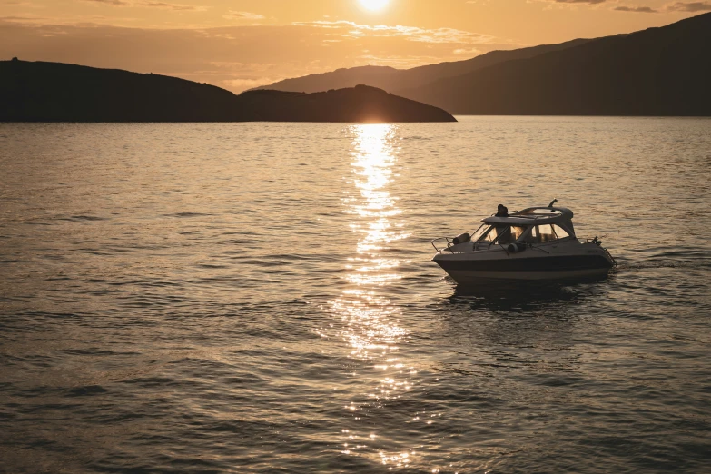 boat with two people sitting on it in a body of water