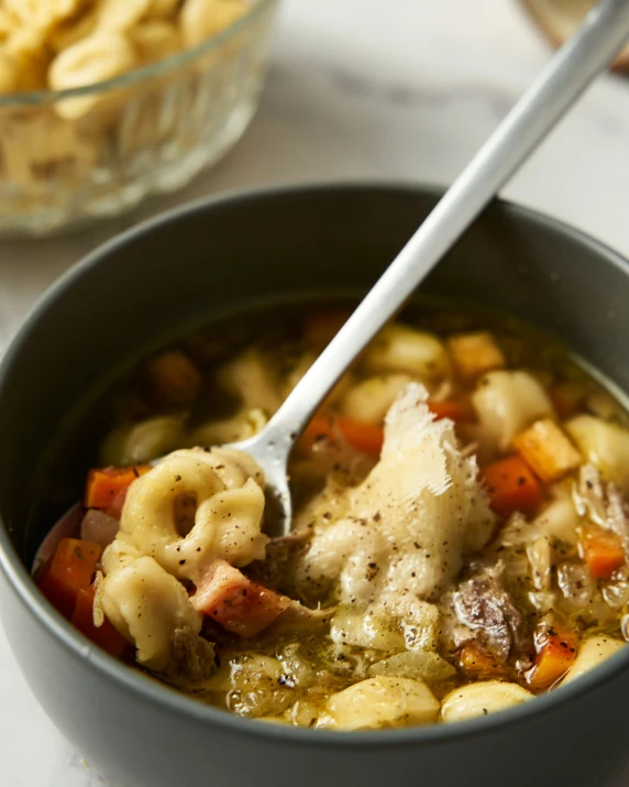 a bowl of chicken pot pie soup with a spoon