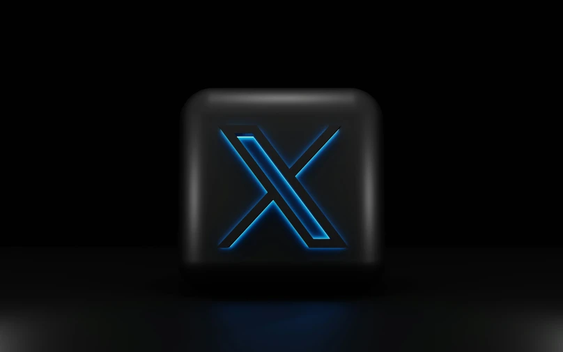 the letter x glowing on an abstract black background