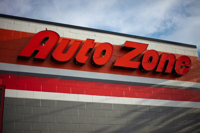 the sign for the autozone store is written on the wall