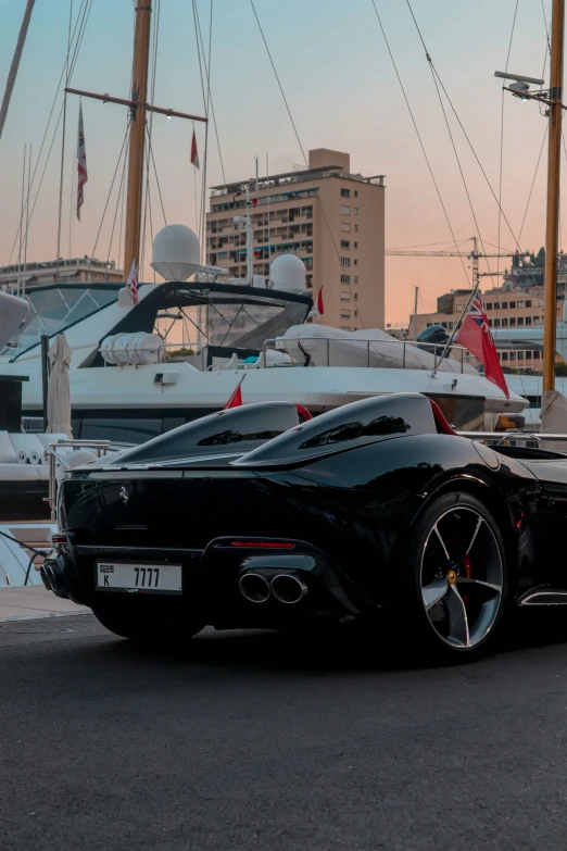 a very nice looking fancy looking sports car parked next to the water