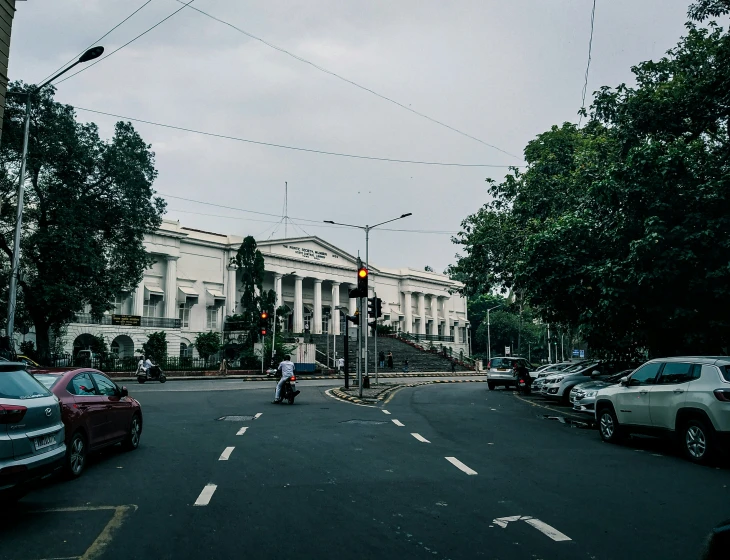 a street filled with traffic and tall white buildings