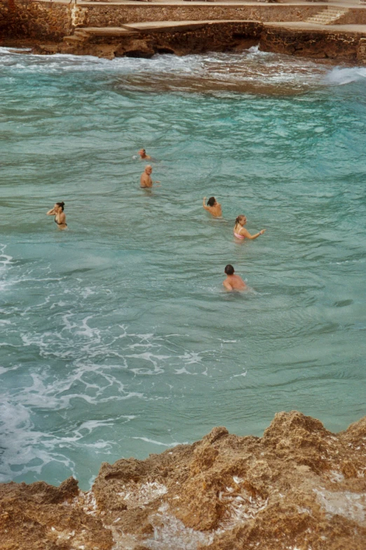 many people swimming in a large body of water