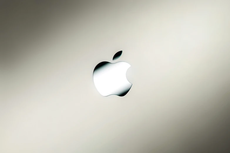 an apple logo is seen on the side of an apple laptop