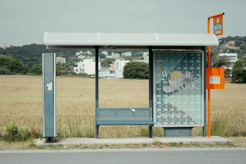 a bus stop in the middle of a field