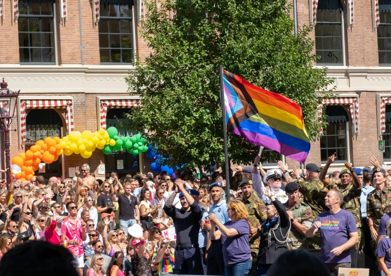 there are many people waving their rainbow flags