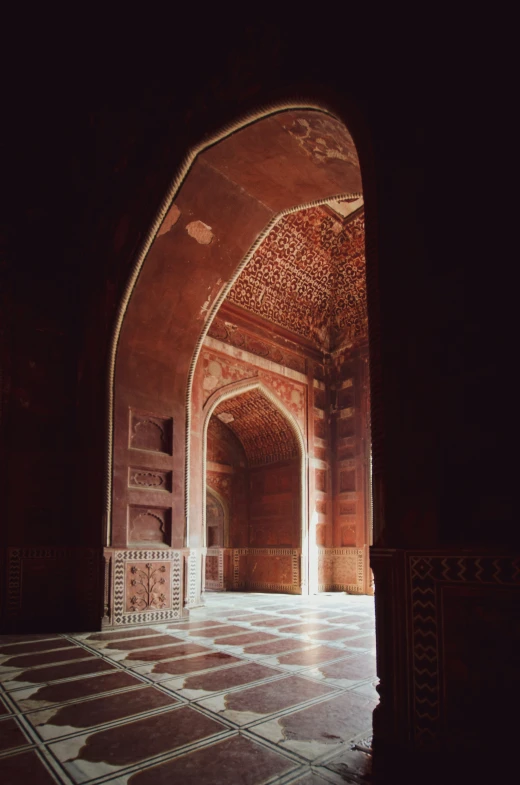 a room that has an archway and tiled floor