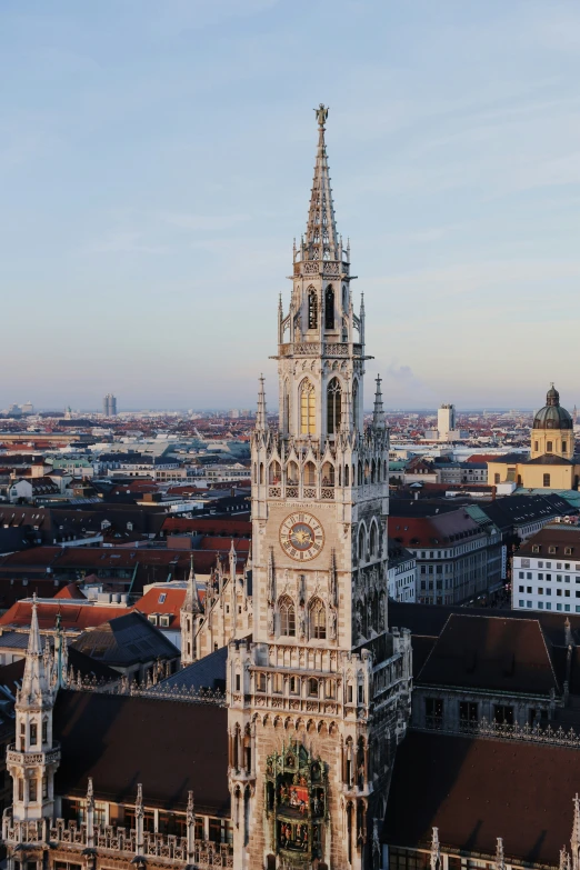 a clock tower above many other buildings near each other