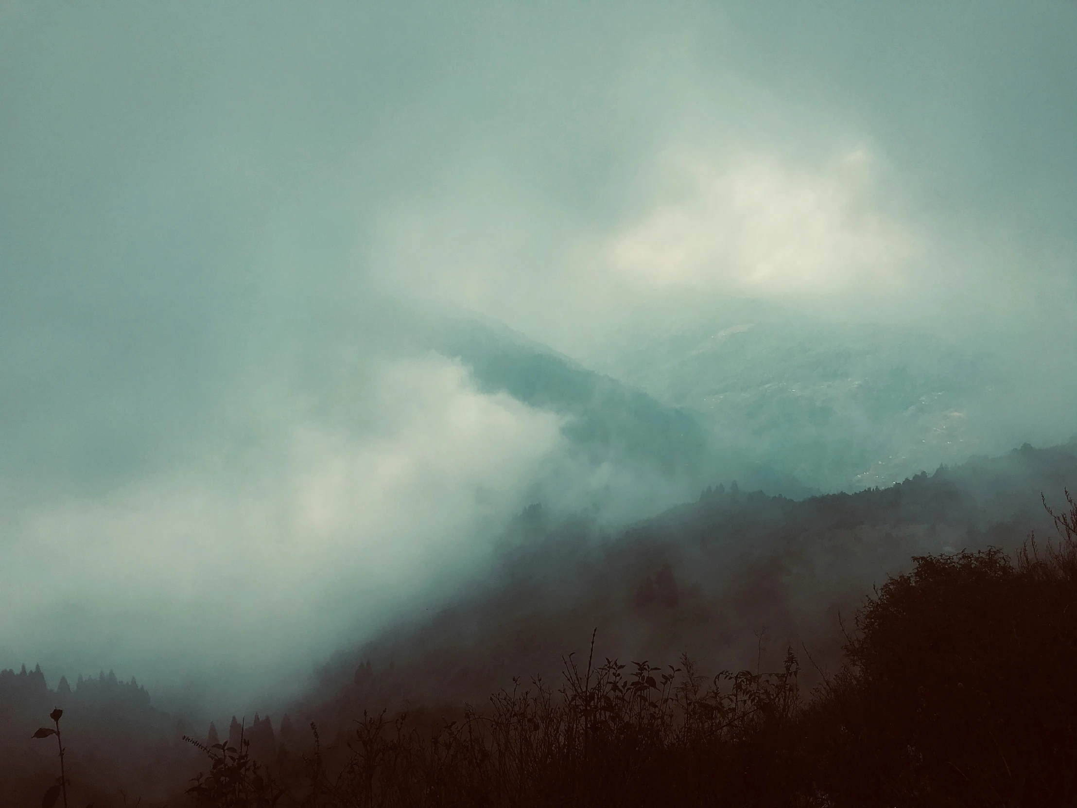 a mountain with clouds is pictured in this image