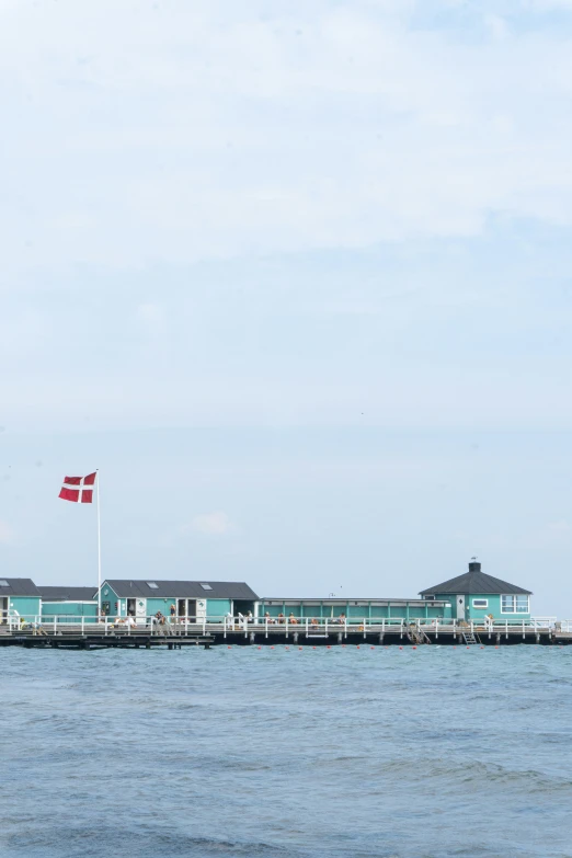 a lighthouse with a canadian flag flying over it