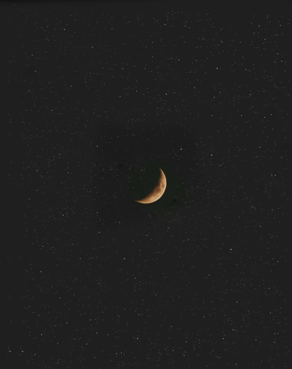 a crescent moon is shown against the stars in a night sky