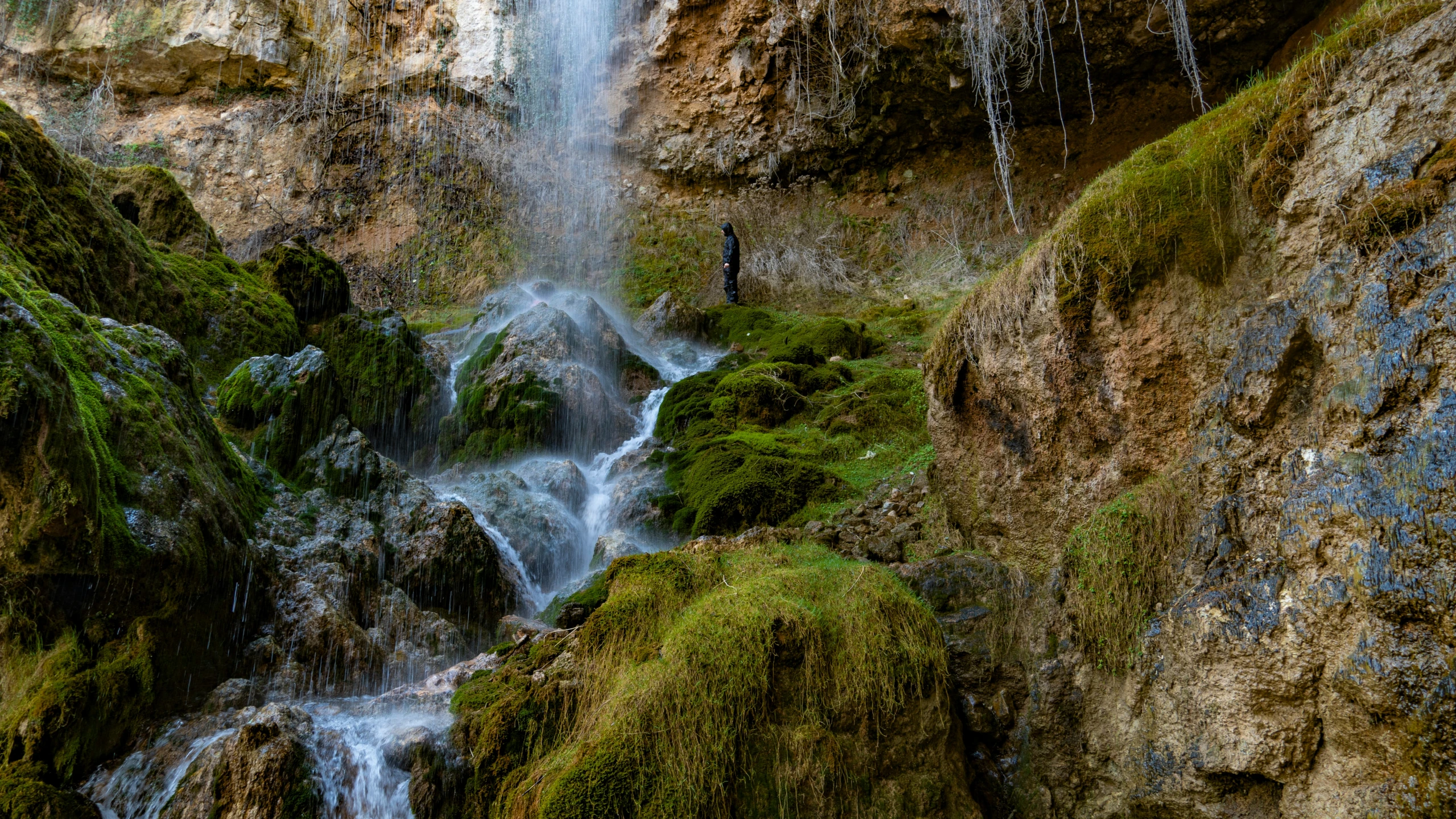 there is a waterfall that is pouring water into the river