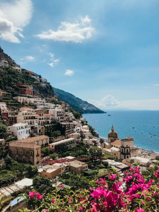 a landscape s of houses on the side of a cliff overlooking the ocean