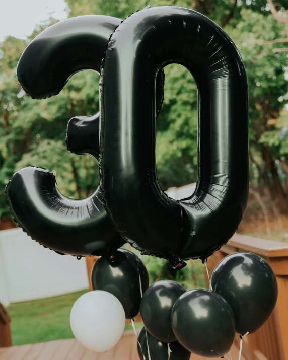an fifty nine balloon, one balloon with the number 50 written in it
