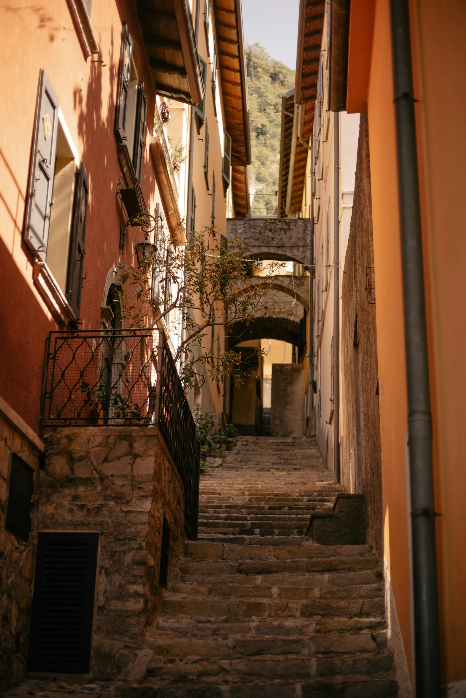 a steep stairway leads down to an alleyway