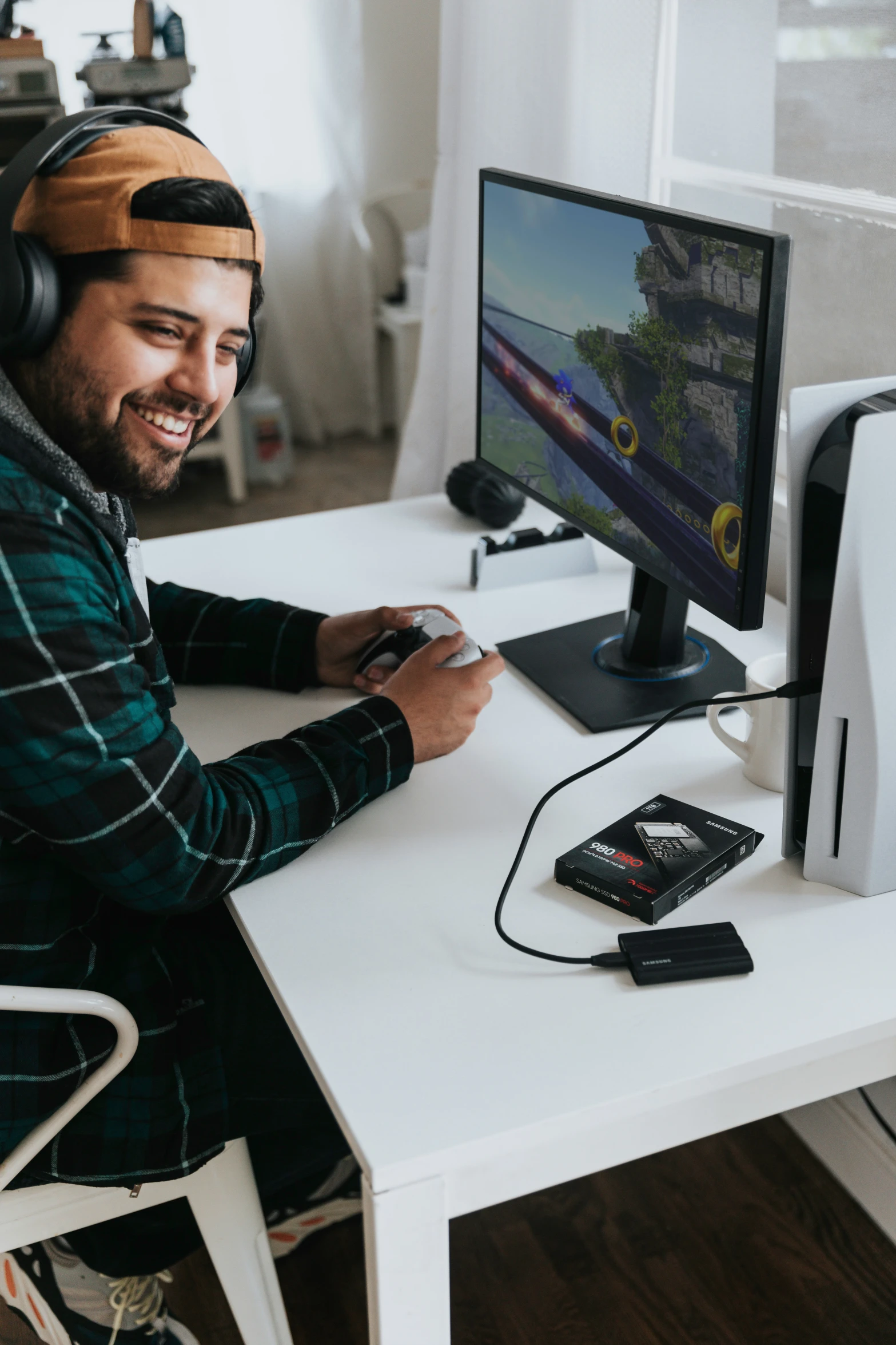 man in plaid shirt and ear muffs working on computer