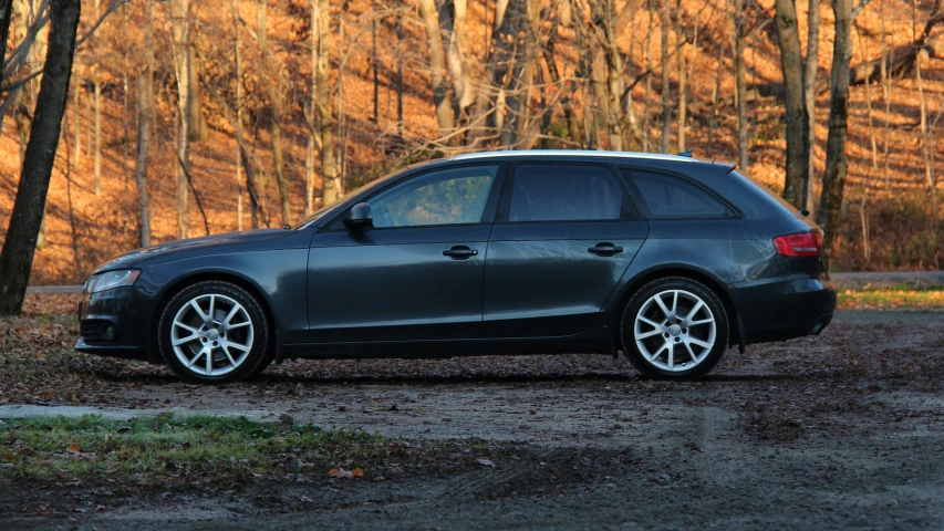 black colored car parked in a muddy parking space