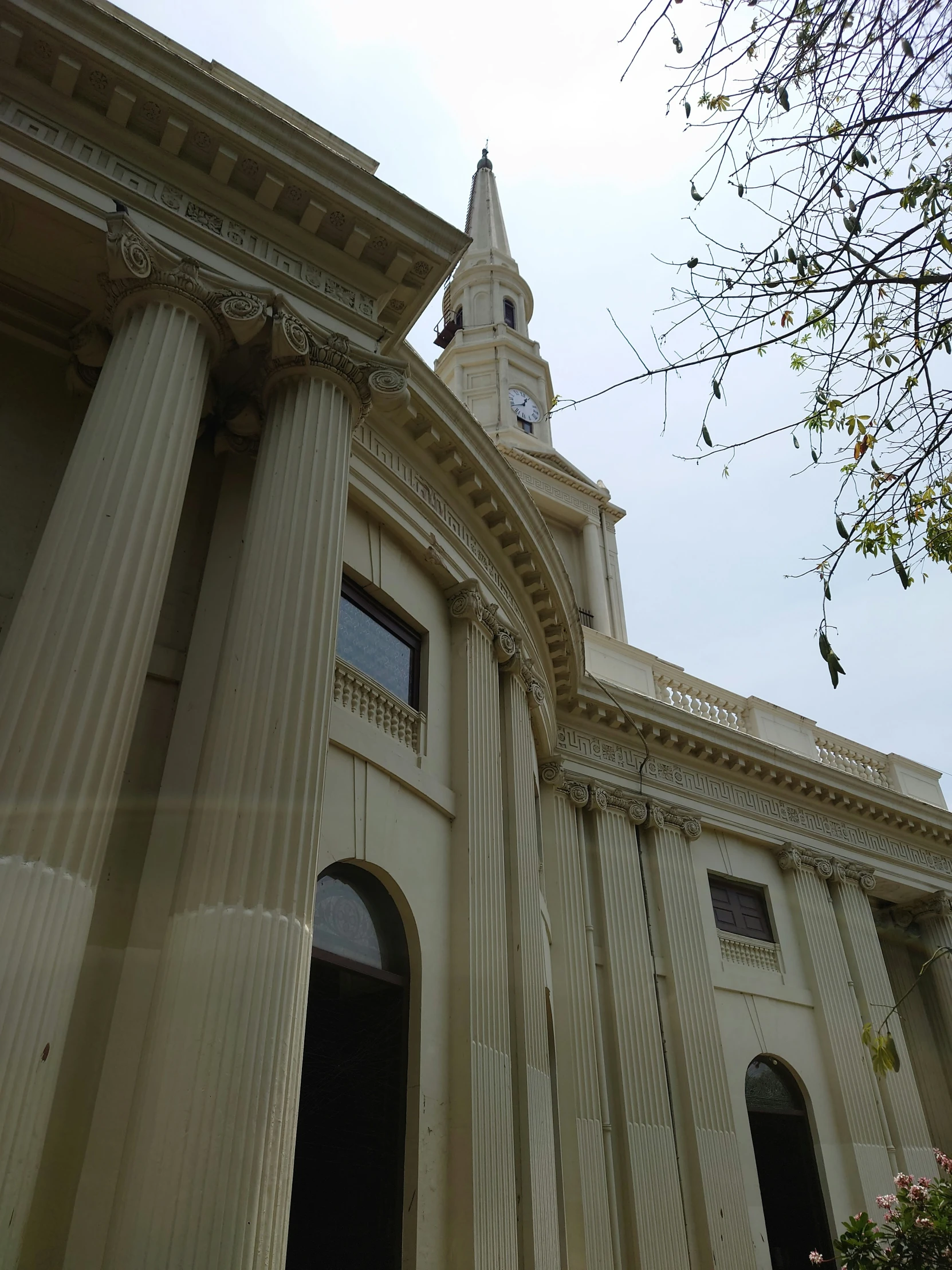 a tall building with pillars and a clock