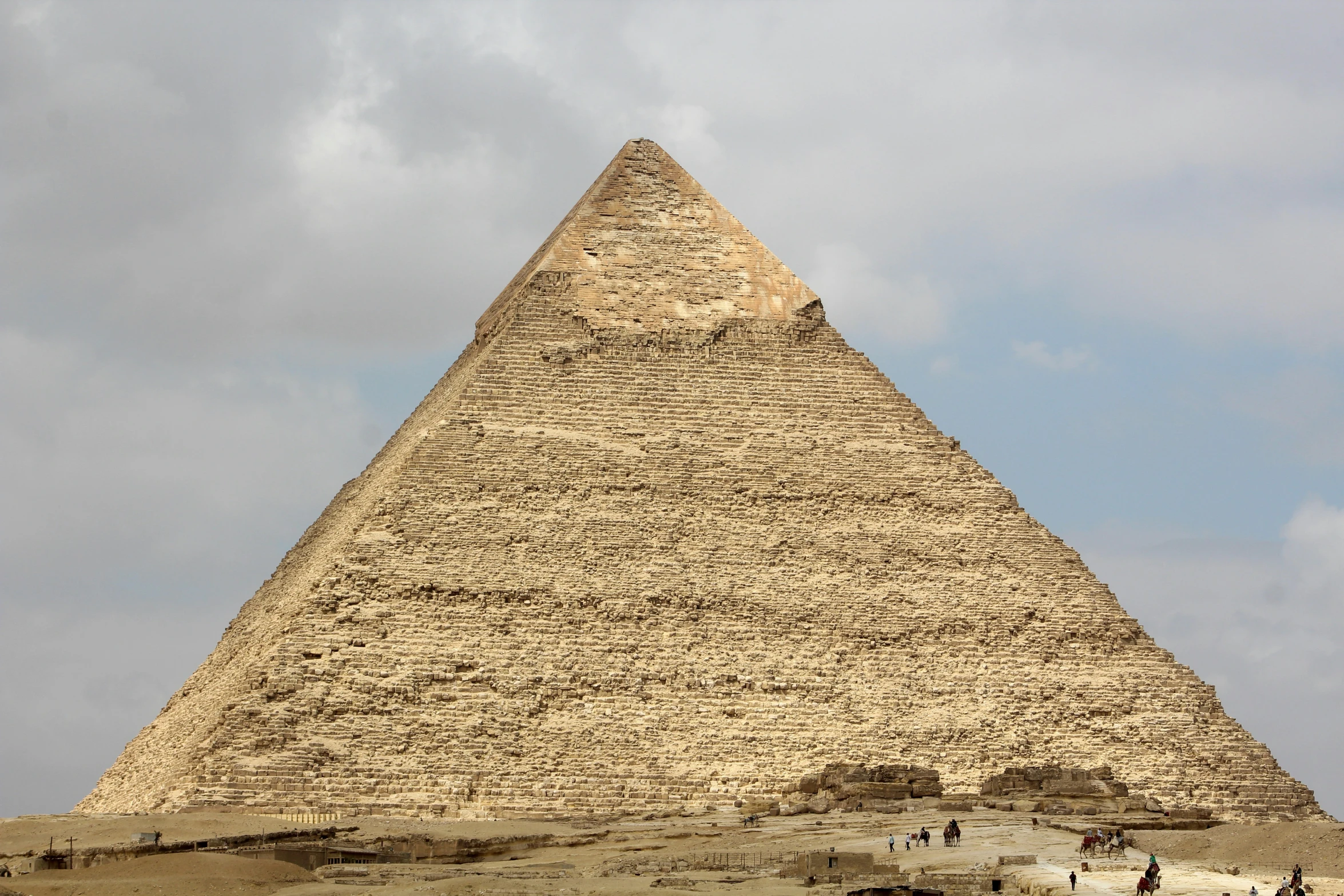 a very tall pyramid near the ocean on a cloudy day