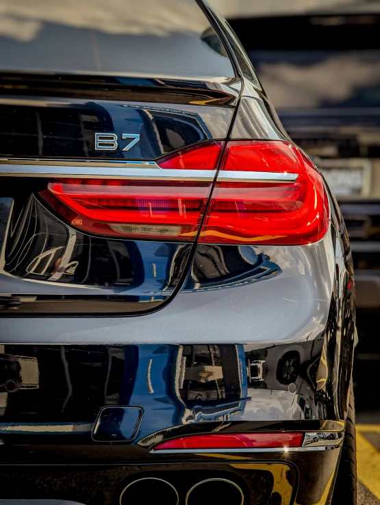 the tail lights on the rear of a black car