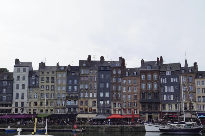 a group of buildings on the water with boats docked in front of them